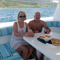 Couple having lunch during their Catamaran sailing trip
